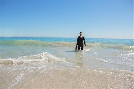 sand case - Young businessman in the water Stock Photo - Premium Royalty-Free, Code: 6109-06781643