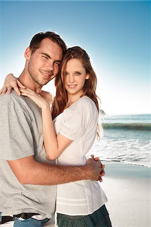 romantic couple on sunny beach - Young couple embracing and posing on the beach Stock Photo - Premium Royalty-Free, Code: 6109-06781671