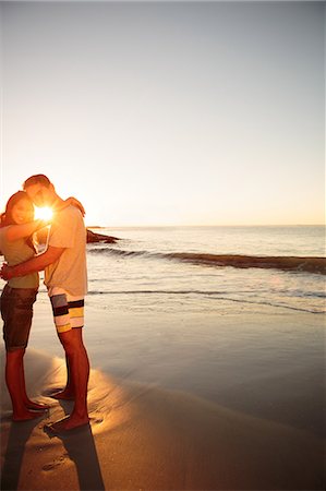 romantic wave seashore - Cheerful lovers embracing each other on the beach Stock Photo - Premium Royalty-Free, Code: 6109-06781697