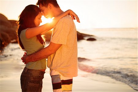 smart couple intelligent - Couple embracing each other on the beach Stock Photo - Premium Royalty-Free, Code: 6109-06781694