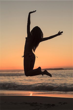 simsearch:6109-06781824,k - Woman jumping on the beach Stock Photo - Premium Royalty-Free, Code: 6109-06781797