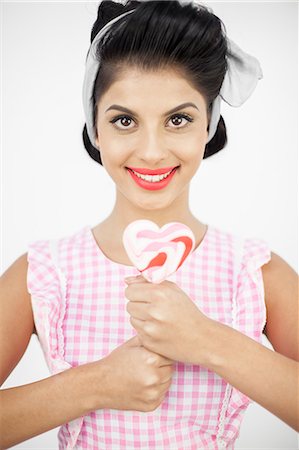 Pretty young pinup holding a lollipop Stock Photo - Premium Royalty-Free, Code: 6109-06781851