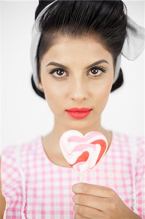Glamorous pinup holding a lollipop Stock Photo - Premium Royalty-Free, Code: 6109-06781856