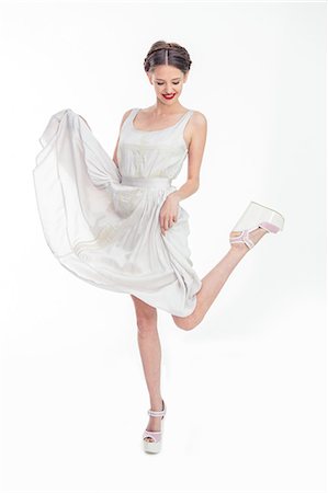 raised - Pretty teen raising her dress and her leg Stock Photo - Premium Royalty-Free, Code: 6109-06781867
