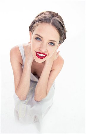 Cheerful fresh teen with red lipstick crouched Photographie de stock - Premium Libres de Droits, Code: 6109-06781869