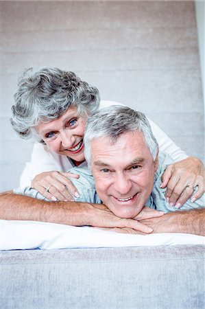 simsearch:6109-06781880,k - Mature couple cuddling and lying together Stock Photo - Premium Royalty-Free, Code: 6109-06781877