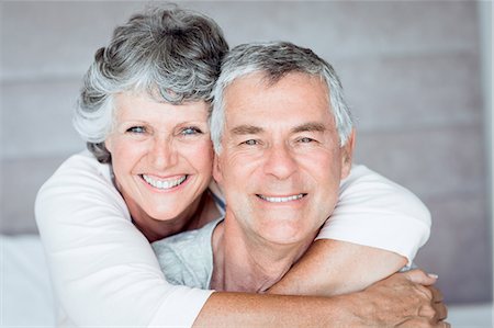 romantic couple in bed - Mature woman embracing her husband Stock Photo - Premium Royalty-Free, Code: 6109-06781885
