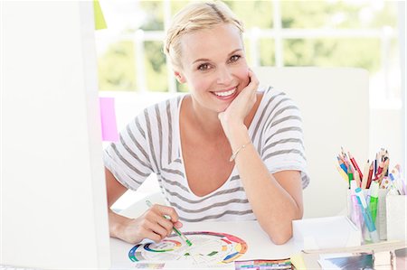 employment agency - Happy designer working with a colour wheel Stock Photo - Premium Royalty-Free, Code: 6109-06781899