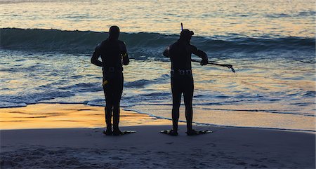 fins - SIlhouettes of people holding snorkeling equipment Stock Photo - Premium Royalty-Free, Code: 6109-06781803