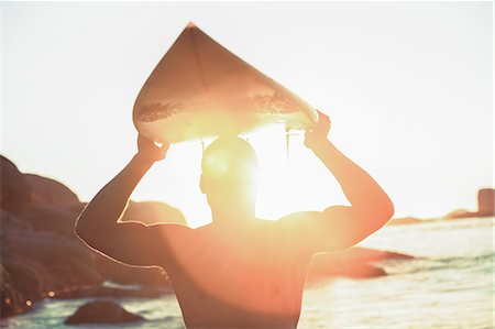 silhouette head - Surfer holding his surfboard and looking at the sea Stock Photo - Premium Royalty-Free, Code: 6109-06781813