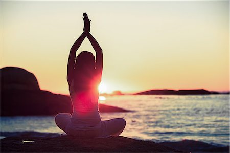 practising alone - Woman doing yoga on a beach Stock Photo - Premium Royalty-Free, Code: 6109-06781826