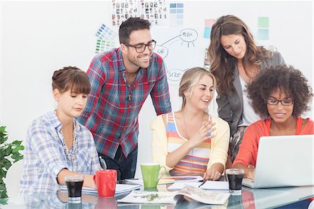 Team of creative designers working on a laptop Stock Photo - Premium Royalty-Free, Code: 6109-06781963