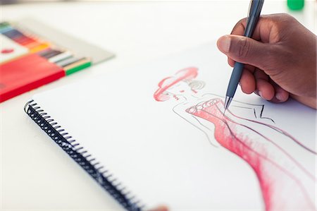 drawing - Man drawing clothes with a pencil Stock Photo - Premium Royalty-Free, Code: 6109-06781929