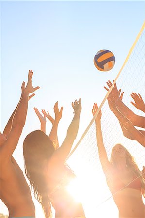 Friends playing volleyball on the beach Stock Photo - Premium Royalty-Free, Code: 6109-07496965