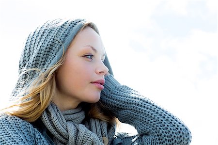 smiling in the wind with scarf - Pretty young woman wearing a scarf and looking away Stock Photo - Premium Royalty-Free, Code: 6109-07496990