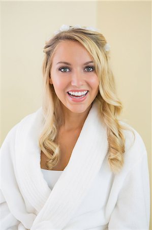 Beautiful happy bride smiling at camera wearing a bath robe Stock Photo - Premium Royalty-Free, Code: 6109-07497381