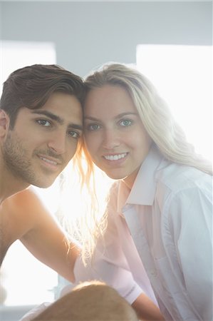 simsearch:6109-07497339,k - Attractive young couple posing sitting on their bed in their bedroom Stockbilder - Premium RF Lizenzfrei, Bildnummer: 6109-07497318