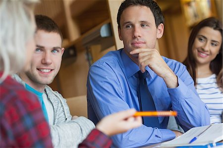 Focused lecturer explaining something to group of students in library in a college Stockbilder - Premium RF Lizenzfrei, Bildnummer: 6109-07497485