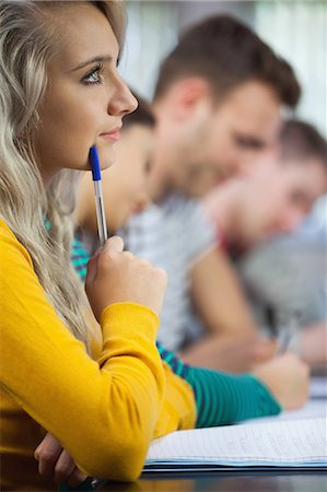 simsearch:6113-07906434,k - Thoughtful blonde student looking away in classroom in a college Stock Photo - Premium Royalty-Free, Code: 6109-07497556