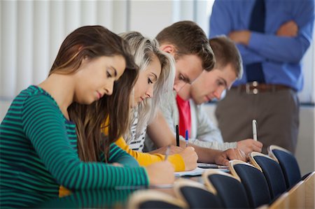pondering in a university classroom - Calm students having an exam in classroom in a college Stock Photo - Premium Royalty-Free, Code: 6109-07497564