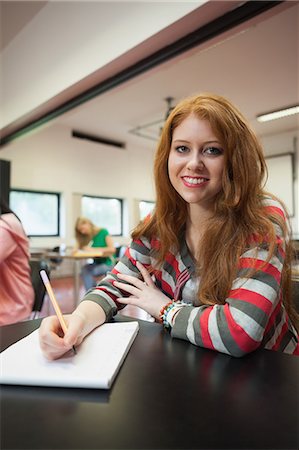 simsearch:6109-07497606,k - Happy female student looking at camera in class at the university Stockbilder - Premium RF Lizenzfrei, Bildnummer: 6109-07497594