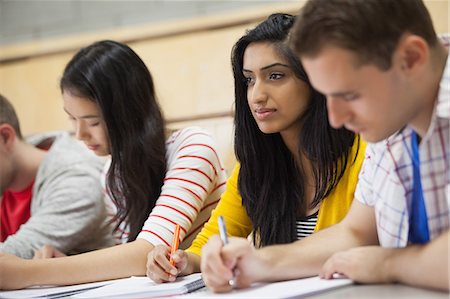 simsearch:6109-07497607,k - Row of happy students listening in a lecture hall in college Foto de stock - Sin royalties Premium, Código: 6109-07497655