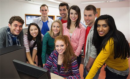 e-learning - Happy students standing at computer in the computer room in college Stock Photo - Premium Royalty-Free, Code: 6109-07497676