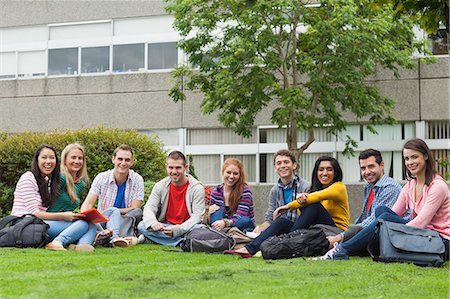 Group of students smiling at camera on the grass on campus at the university Stock Photo - Premium Royalty-Free, Code: 6109-07497686