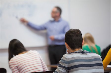 simsearch:6109-07497644,k - Students listening to their teacher in classroom at the university Stock Photo - Premium Royalty-Free, Code: 6109-07497603