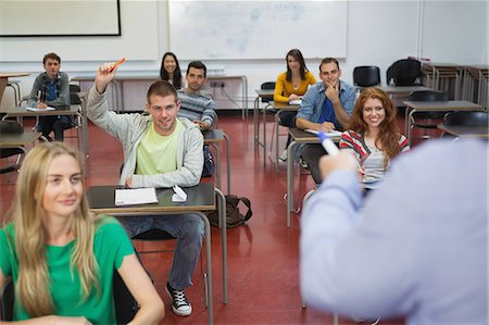 Student raising his hand to ask a question in class at the university Foto de stock - Sin royalties Premium, Código: 6109-07497616