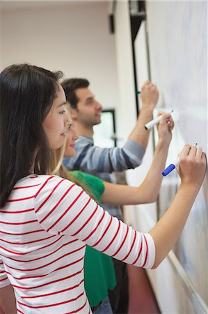 Students writing on the whiteboard together in class at the university Stockbilder - Premium RF Lizenzfrei, Bildnummer: 6109-07497618