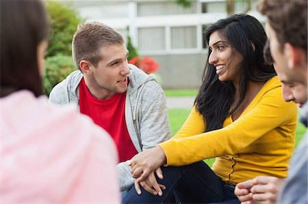 friends talking on college campus - Cheerful young students taking a break outside on campus at the university Stock Photo - Premium Royalty-Free, Code: 6109-07497700