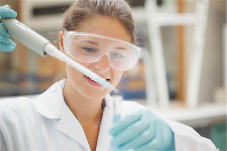 Attractive student holding big pipette in lab at college Stock Photo - Premium Royalty-Free, Code: 6109-07497806