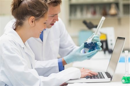 student with laptop in chemistry lab - Two smiling students working at laptop in lab at college Stock Photo - Premium Royalty-Free, Code: 6109-07497813