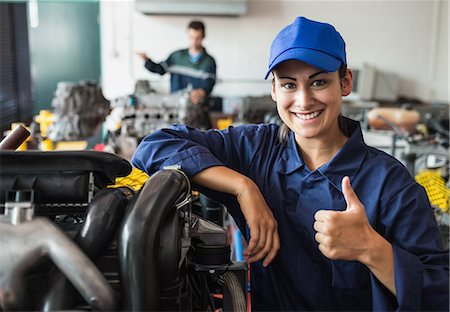 Happy trainee showing thumb up in workshop Stock Photo - Premium Royalty-Free, Code: 6109-07497953