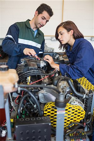 education - Calm instructor explaining a machine to trainee in workshop Stock Photo - Premium Royalty-Free, Code: 6109-07497967