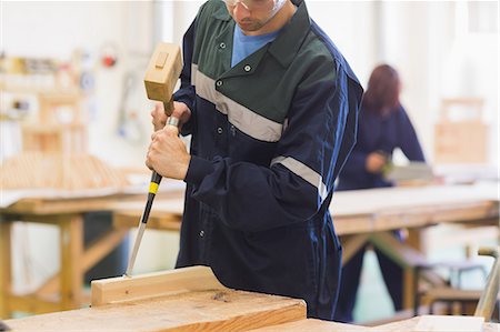 safety training - Craftsman using mallet and chisel in workshop Stock Photo - Premium Royalty-Free, Code: 6109-07498002