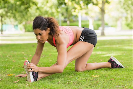 simsearch:6109-08435603,k - Full length of a toned and flexible woman doing stretching exercise in the park Stock Photo - Premium Royalty-Free, Code: 6109-07498036