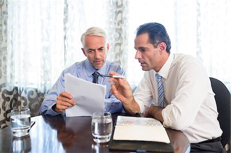 staff (male) - Businessmen doing paperwork at office desk Stock Photo - Premium Royalty-Free, Code: 6109-07600851