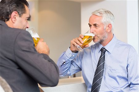 simsearch:6109-08582068,k - Business colleagues drinking beer at bar counter Stock Photo - Premium Royalty-Free, Code: 6109-07600871