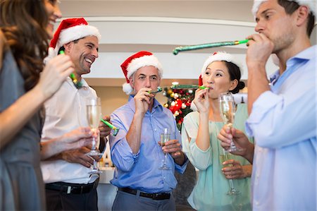 friends women indoors happy middle aged - People in Santas hats with champagne flutes and noise makers Stock Photo - Premium Royalty-Free, Code: 6109-07600931