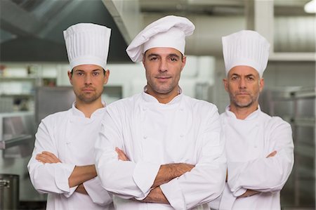 simsearch:6109-07601170,k - Serious team of chefs looking at the camera Photographie de stock - Premium Libres de Droits, Code: 6109-07601043