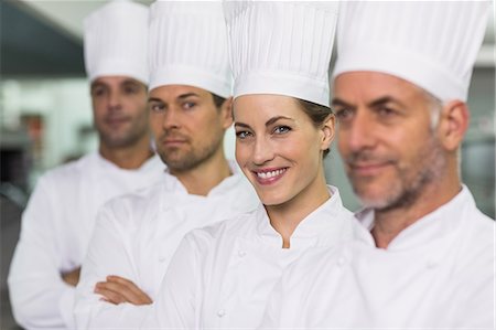 Happy team of chefs standing in line Foto de stock - Sin royalties Premium, Código: 6109-07601044