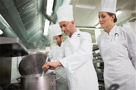saucepan - Head chef tasting a soup while colleague watches Stock Photo - Premium Royalty-Free, Code: 6109-07601067