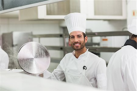 restaurant kitchen - Happy chef lifting a lid off a pot Stock Photo - Premium Royalty-Free, Code: 6109-07601072