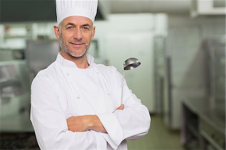 Confident chef with arms crossed holding a ladle Stock Photo - Premium Royalty-Free, Code: 6109-07601037