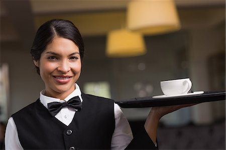 simsearch:6109-07601183,k - Pretty waitress holding a tray with a cup Foto de stock - Sin royalties Premium, Código: 6109-07601188