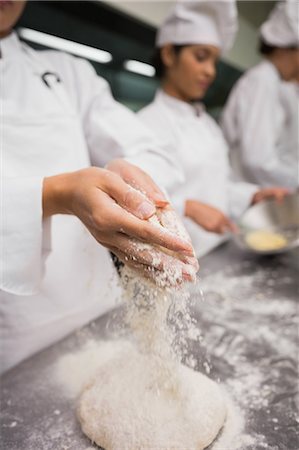 Chef preparing dough at counter Stock Photo - Premium Royalty-Free, Code: 6109-07601112