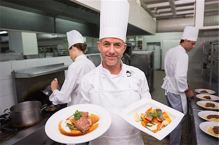 seafood food presentation - Happy chef holding steak dinner and salmon dinner Stock Photo - Premium Royalty-Free, Code: 6109-07601130