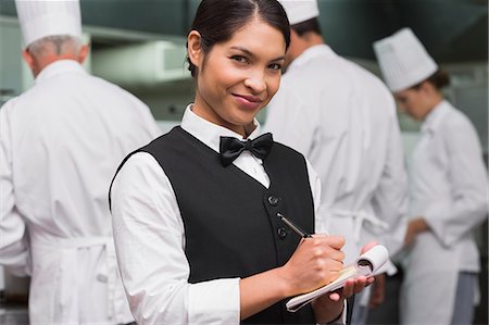 personnel (employé) - Happy waitress writing on pad Photographie de stock - Premium Libres de Droits, Code: 6109-07601135